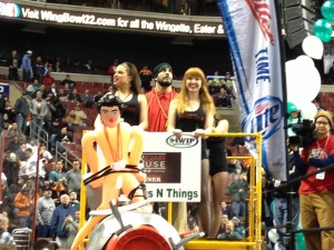 Dave "DJ" Brunelli enters on the first float of Wing Bowl 22 last Friday. A mock broadcast booth, the rubber doll affixed to a cannon was his entourage's "goodbye" to Chris Wheeler. -photo by Joe Darrah